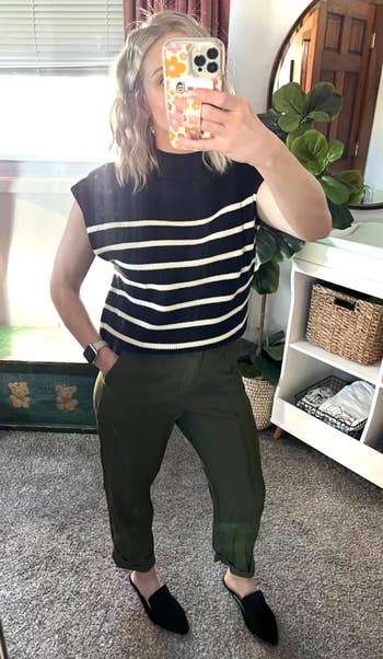 Person in a striped top, green pants, and black shoes