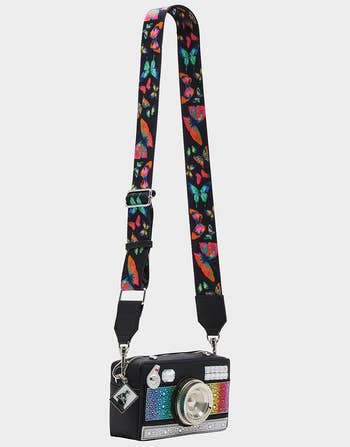 view of the bag with black and rainbow butterfly strap and betsey charm