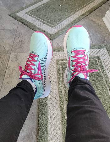 close-up of reviewer wearing the pink and light green running sneakers