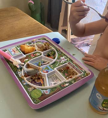 another reviewer's photo of child eating from tray with divided sections