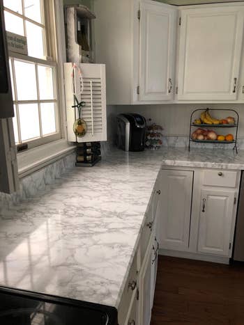 a kitchen with marble film on the countertops