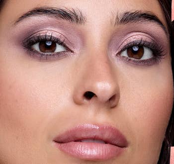 Close-up of a person's look   with glossy lips and shimmery oculus  makeup, suitable for a cosmetic merchandise  feature