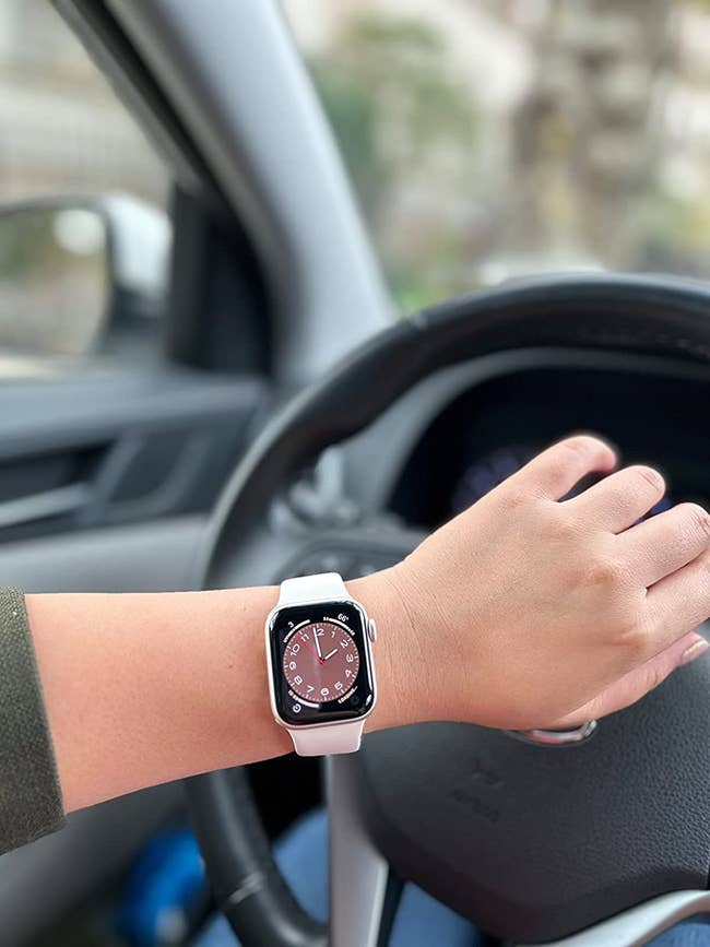 Reviewer wearing the starlight watch with a pink watch face on the screen