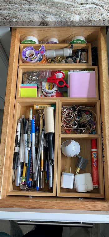 a reviewer's drawer with bins organizing their junk