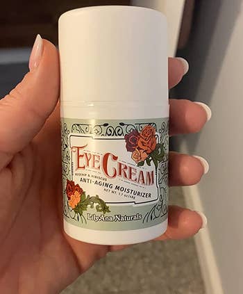 a reviewer holding the eye cream
