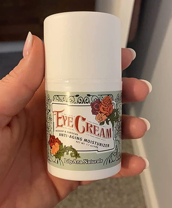 a reviewer holding the eye cream