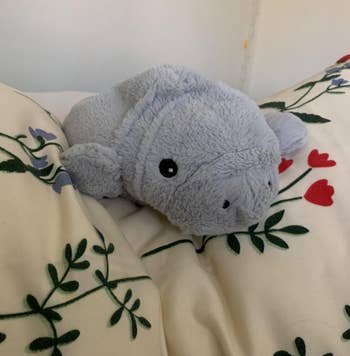 the manatee heating pad on a reviewer's bed