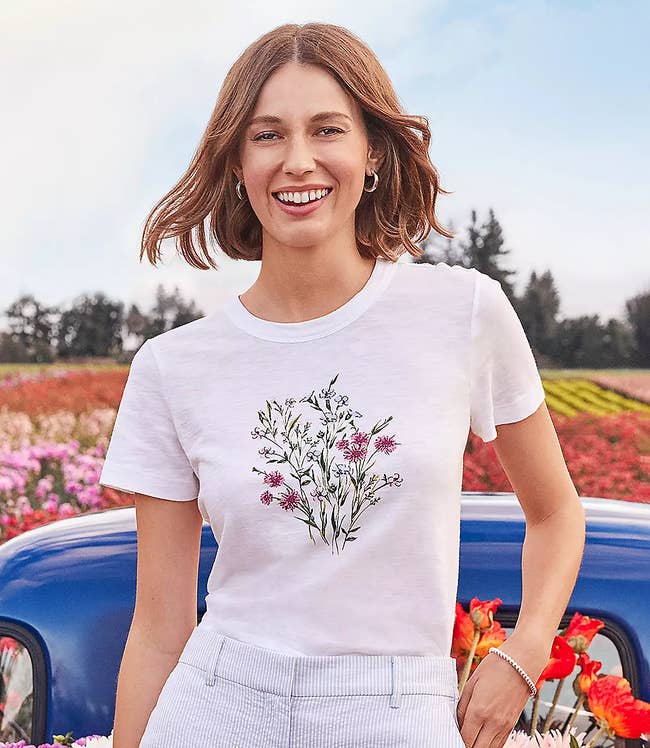 model in white crewneck short sleeve tee with flower bouquet graphic