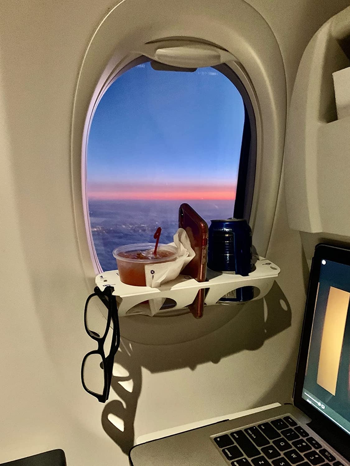 I apologize for the pic, but this is a BevLedge and I think its awesome.  When unfolded, it fits into the window shade slot on most airplanes. This  post has been taken down elsewhere because apparently self-promotion  means you can't talk about products (its