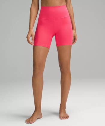 a model in pink lululemon bike shorts