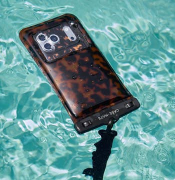 phone pouch with a tortoise ammunition plan floating successful the water