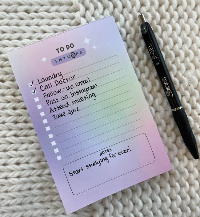 a purple note pad with a checklist template 