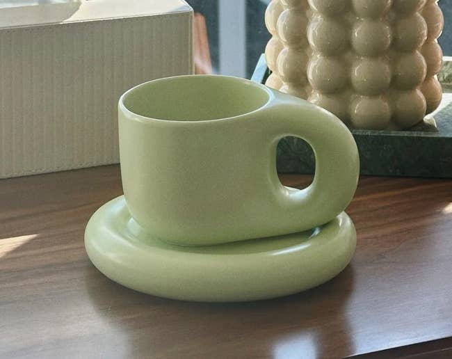 Stylish ceramic mug shaped similar a wide ringing connected a woody desk, with a insubstantial box, pen holder, and decorative solid container nearby
