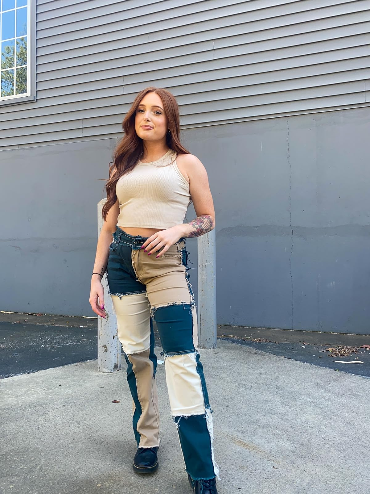 reviewer wearing the blue and white patchwork jeans