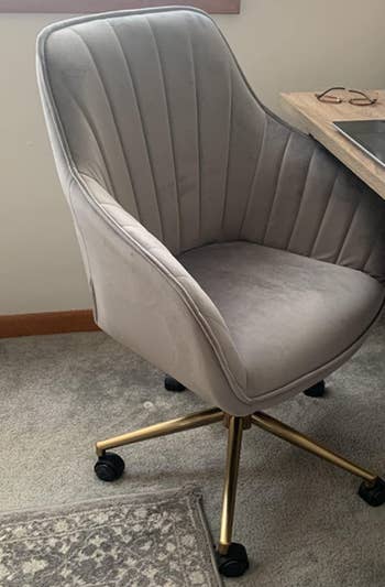the same office chair in gray with gold legs that roll