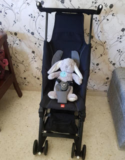 reviewer photo of the black stroller holding a stuffed bunny