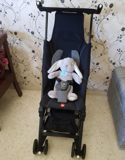 reviewer photo of the black stroller holding a stuffed bunny