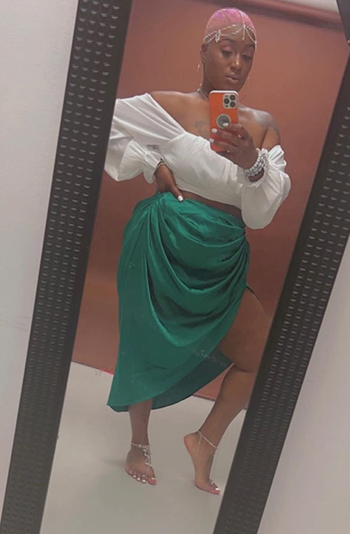 another reviewer wearing the green skirt