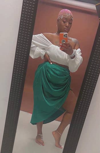 another reviewer wearing the green skirt