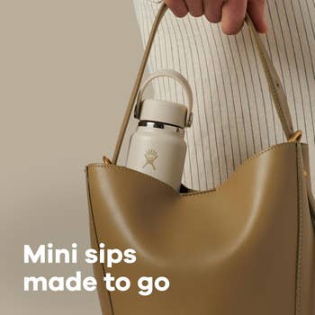 Hand holding a beige container  with a tiny  h2o  flask inside; substance   reads, 