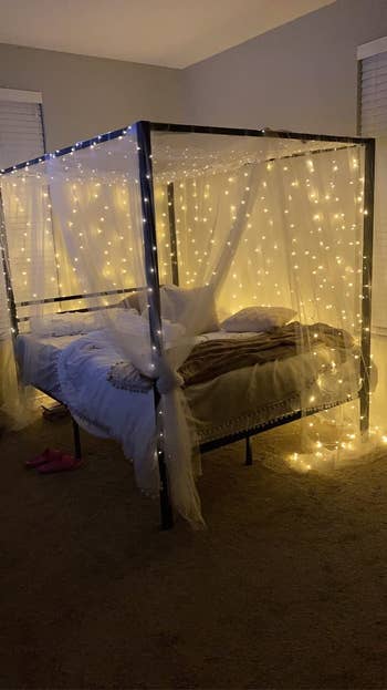 reviewers canopy bed with fairy lights on it