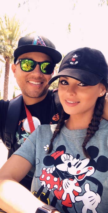 a reviewer wearing a black hat with mickey embroidered on it