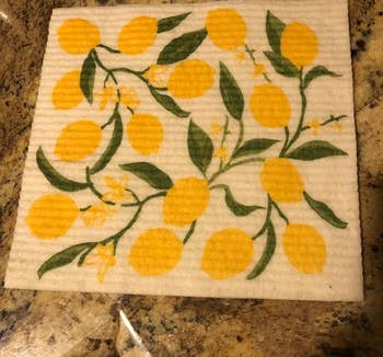 a reviewer photo of one of the dishcloths featuring a lemon print 