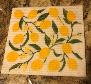 a reviewer photo of one of the dishcloths featuring a lemon print 
