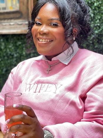 reviewer wearing the achromatic  collar with a sweater