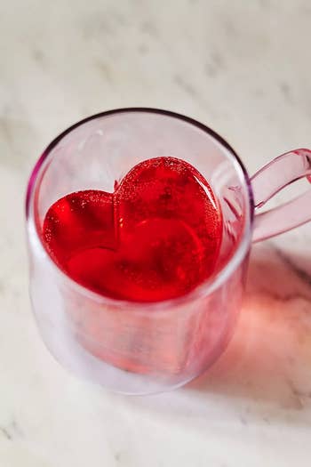 a lilac mug glass wiith a heart-shape inside