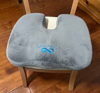 Reviewer image of the gray seat cushion on wooden chair
