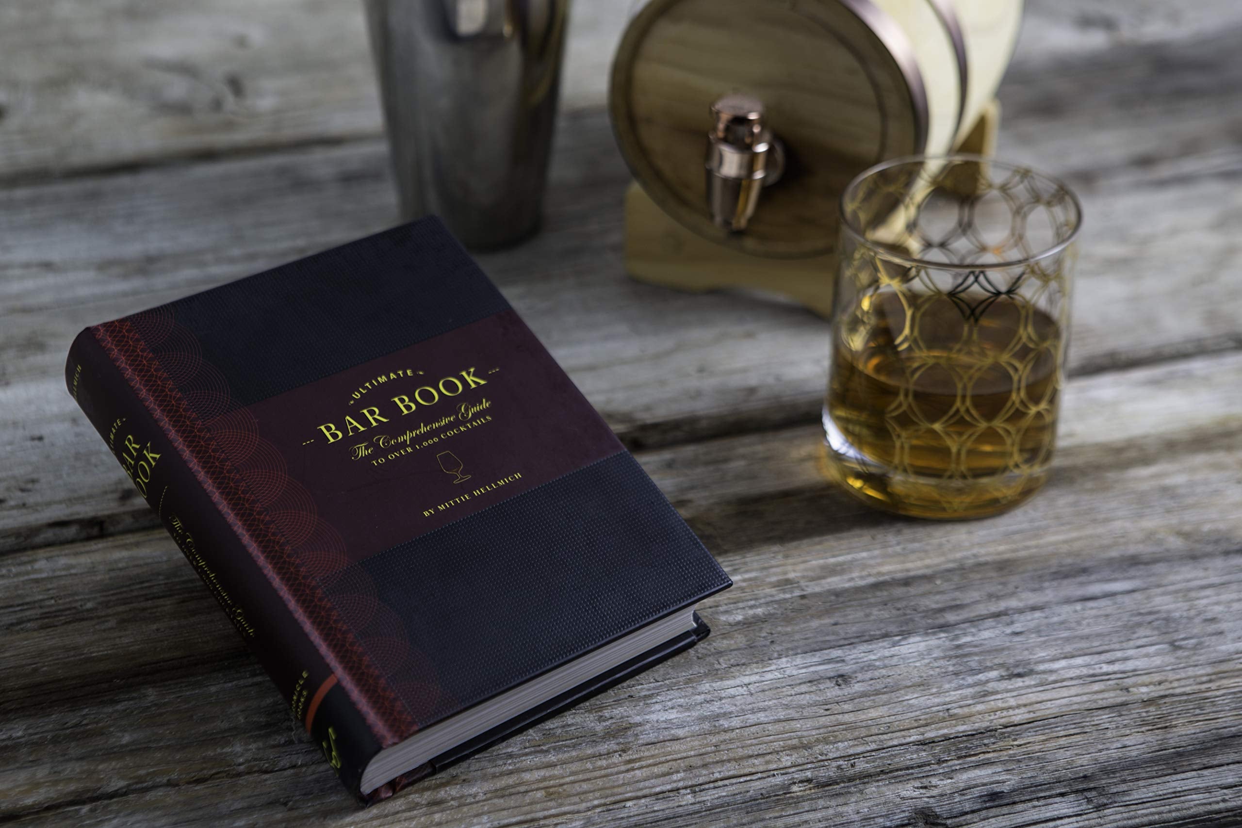 the book next to a glass filled with a drink
