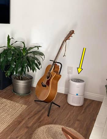 Reviewer's living room with an air purifier in the corner indicated by an arrow