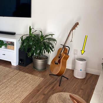 Reviewer's living room with an air purifier in the corner indicated by an arrow
