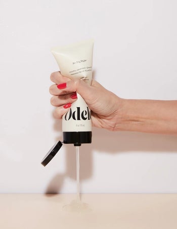 model squeezing the cream into their hand