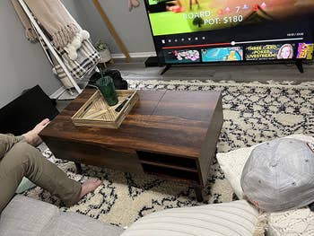 reviewer photo of wooden coffee table with storage in front of TV