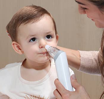 Model utilizing a nasal aspirator connected a babe to wide the child's nasal passages, highlighting its usage successful location healthcare