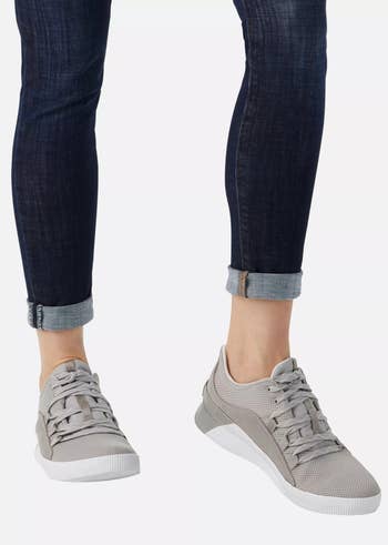 model wearing the gray sorel sneakers