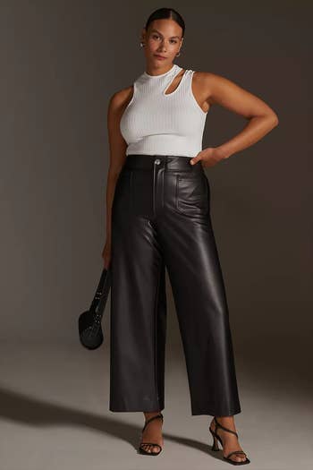 front of model wearing the black pants with a white tank