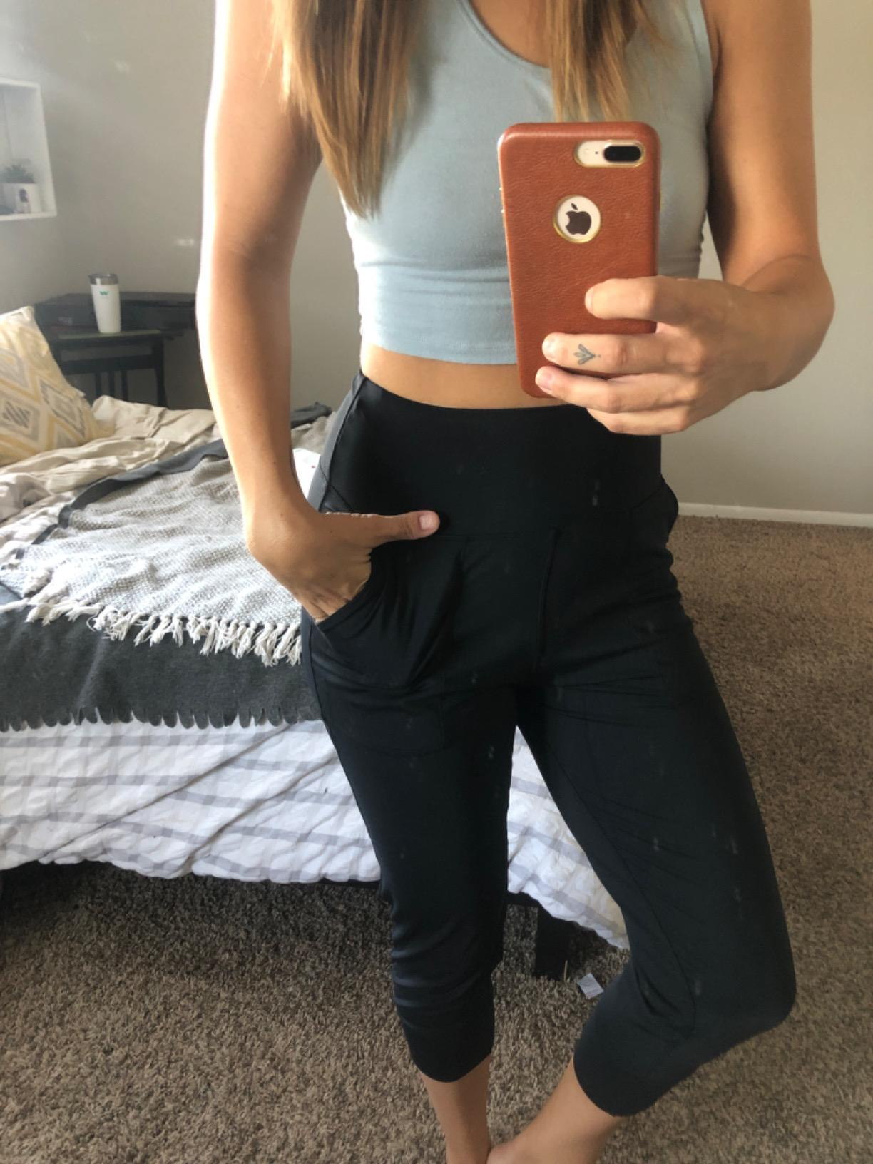 reviewer showing the front of the black joggers
