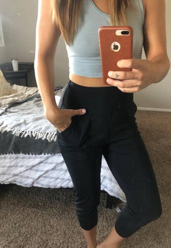 reviewer showing the front of the black joggers