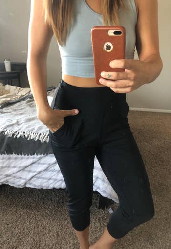 reviewer showing the front of the black joggers