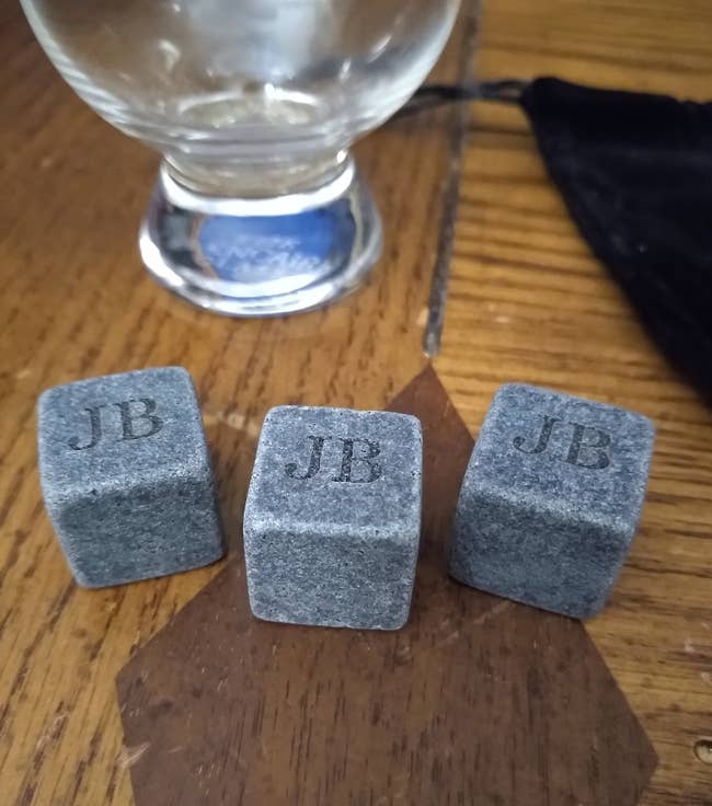 three whiskey cubes engraved with 