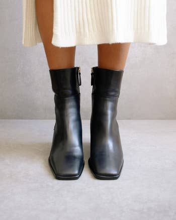 front view of model in black square toe ankle boots