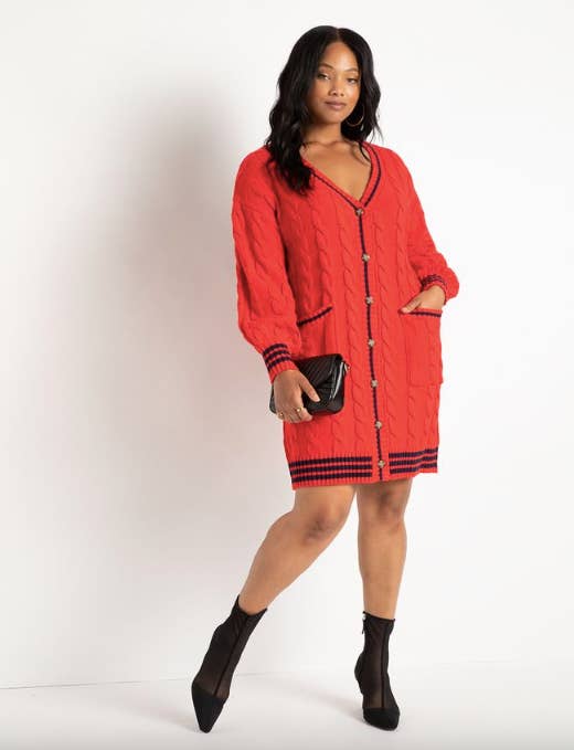 model in above the knee orange cable knit cardigan dress with navy trim