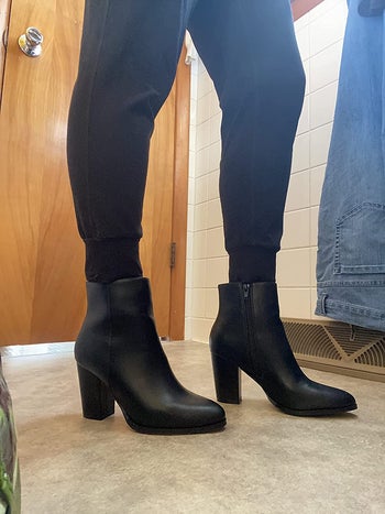 reviewer photo of them showing off black heeled boots from the side