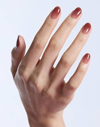 closeup of manus with the Fig Jam nails applied