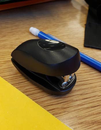 the mini black stapler next to a pencil