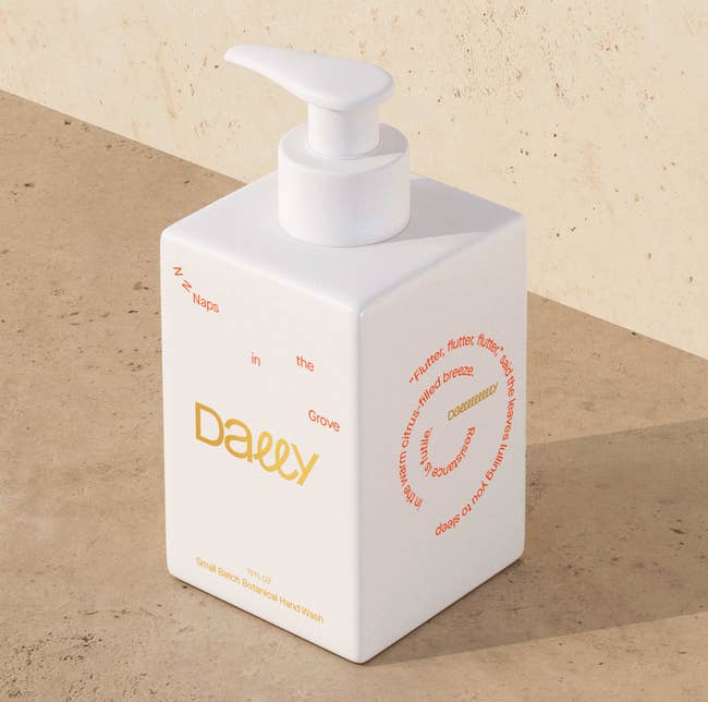 Image of the white soap bottle with gold and orange text