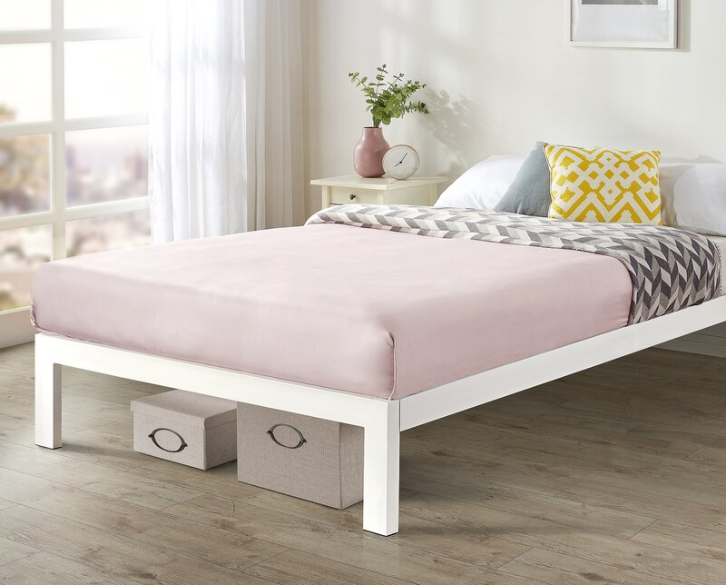 lifestyle image of white steel frame with pink bedding